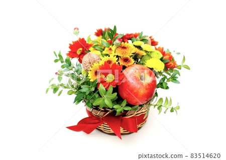 Bouquet of flowers and red apples. Autumn composition in basket on white background 83514620