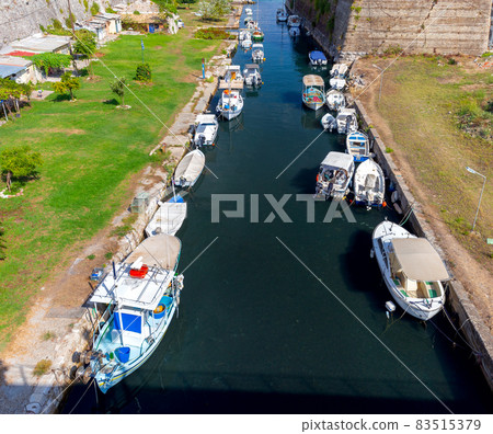 Kerkyra. Canal with fishing boats on a sunny morning. 83515379