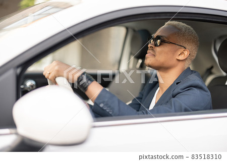 Latin businessman drives his car Latin businessman drives his car 83518310