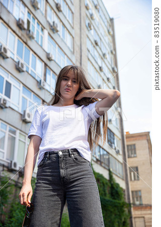 White young european girl with building behind White young european girl with building behind 83519080