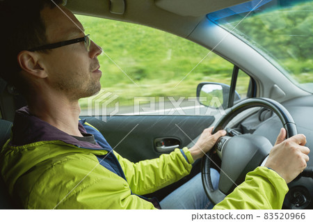 Man drive car. Mountain road. Responsible travel vacation. Staycation concept. Man drive car. Mountain road. Responsible travel vacation. Staycation concept. 83520966