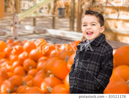 Happy Biracial Boy Having Fun at the Pumpkin Patch Farm. 83521176