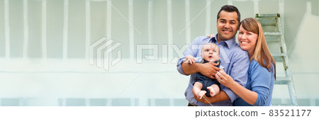 Young Biracial Family Inside Room with New Sheetrock Drywall and Ladder. 83521177