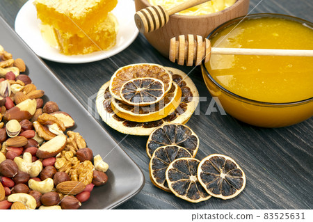 nuts, dried citrus fruits and fresh comb honey. vitamin organic food nuts, dried citrus fruits and fresh comb honey. vitamin organic food 83525631