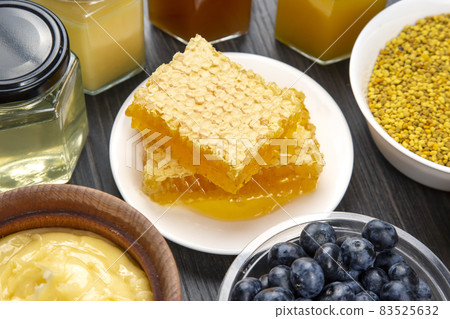 fresh assorted honey and blueberries on a wooden background. healthy organic vitamin food. fresh assorted honey and blueberries on a wooden background. healthy organic vitamin food. 83525632