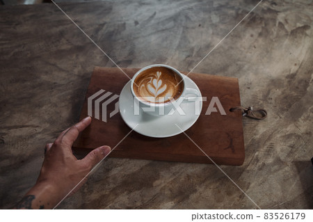 Latte art coffee on wooden table in coffee shop Latte art coffee on wooden table in coffee shop 83526179