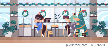 colleagues in santa hats working in office businesspeople celebrating new year christmas holidays colleagues in santa hats working in office businesspeople celebrating new year christmas holidays 83526591