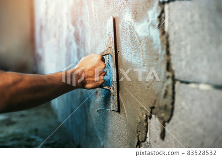 closeup hand of worker plastering cement at wall for building house 83528532