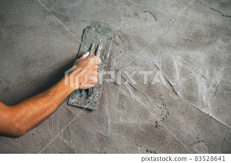 closeup hand of worker plastering cement at wall for building house 83528641