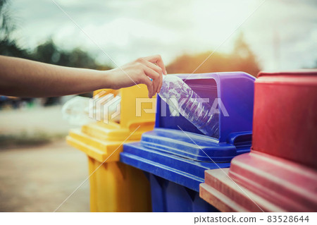 hand holding bottle plastic garbage into trash in park hand holding bottle plastic garbage into trash in park 83528644