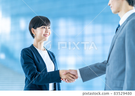 Business men and women shaking hands Business men and women shaking hands 83529480
