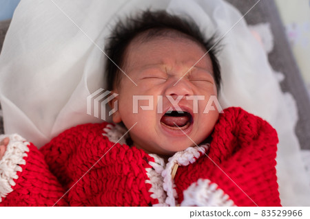 Cute Newborn baby wearing santa costume lying and crying waiting for celebrate merry christmas and happy new year.Angry of infant baby screaming with red santa cloth 83529966