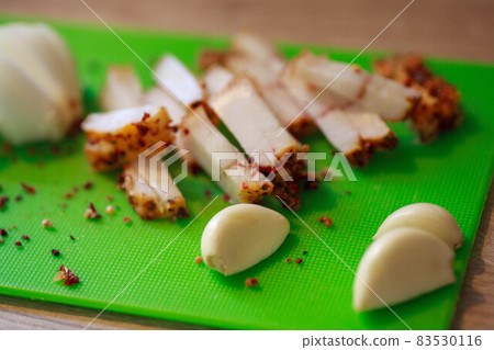 A piece of salted bacon on paper. 83530116