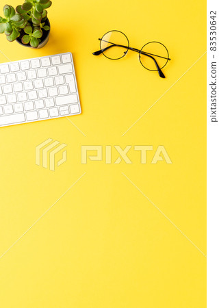 Modern office desktop with computer keyboard and eyeglasses. Business background with copyspace 83530642