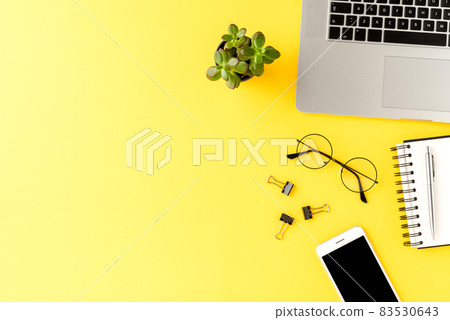 Business background with accessories on yellow table. Office desktop. Top view 83530643