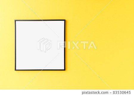 Mockup of empty picture frame on yellow background with copyspace Mockup of empty picture frame on yellow background with copyspace 83530645