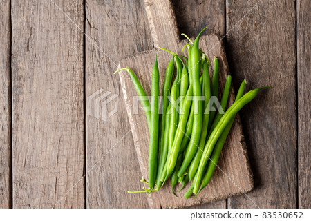 Overhead shot of fresh green bean on wooden table Overhead shot of fresh green bean on wooden table 83530652