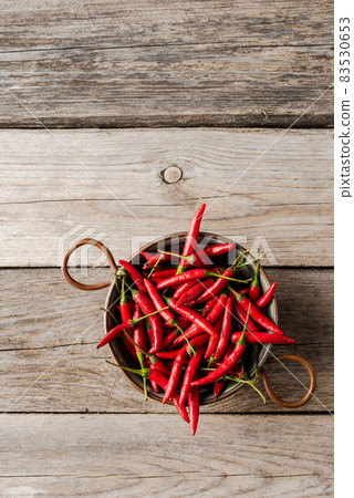 Piri-piri peppers on rustic wooden table Piri-piri peppers on rustic wooden table 83530653