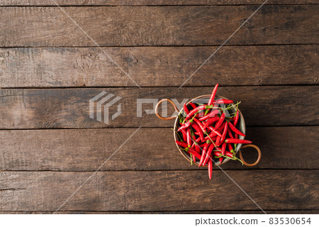 Hot peppers on wooden background Hot peppers on wooden background 83530654