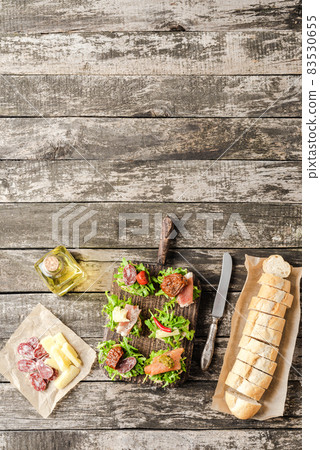 Rustic sandwiches on background with copyspace Rustic sandwiches on background with copyspace 83530655