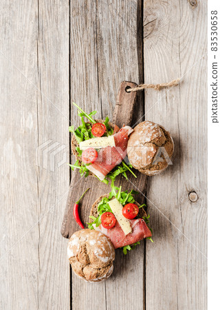 Homemade sandwich on old wooden background 83530658