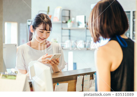A woman who puts out a smartphone at the reception A woman who puts out a smartphone at the reception 83531089