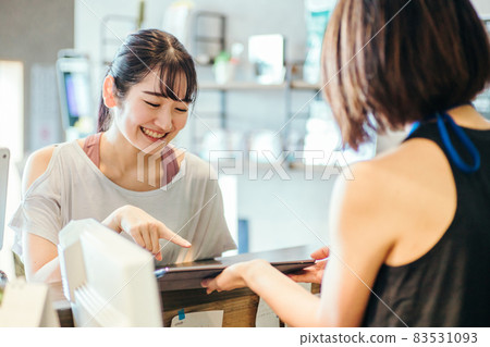 Woman looking at a tablet in a gym 83531093