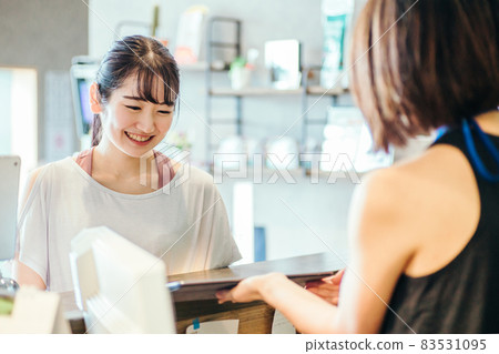 Woman looking at a tablet in a gym 83531095