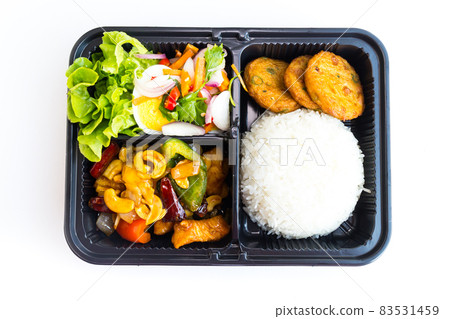 Thai food lunch boxes in plastic packages, Stir fried Chicken with cashew nuts, Fish cake and Spicy Egg Salad. 83531459