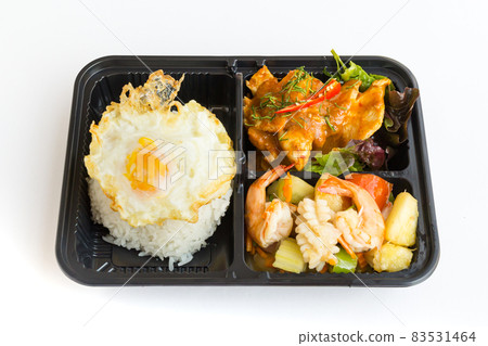 Thai food lunch boxes in plastic packages. Rice with red pork curry and .sweet and sour seafood. Thai food lunch boxes in plastic packages. Rice with red pork curry and .sweet and sour seafood. 83531464
