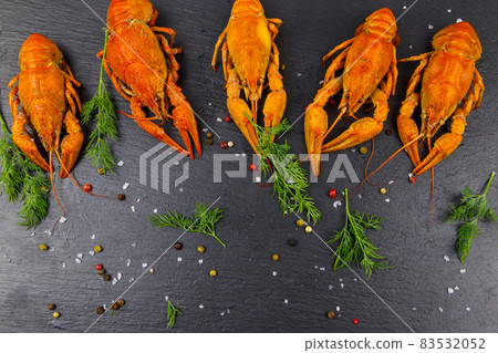 Red boiled crayfish with dill and spices on black slate background. Top view Red boiled crayfish with dill and spices on black slate background. Top view 83532052