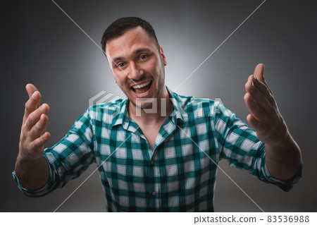 Portrait of excited man looking at the camera and points at you with a finger. 83536988