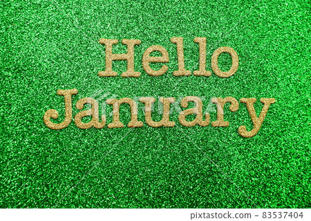 Hello January alphabet letters on green glitter background Hello January alphabet letters on green glitter background 83537404