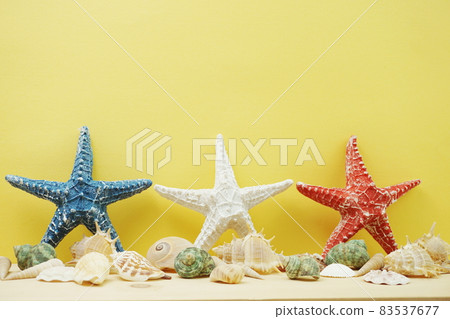 summer background with starfish figure and seashell decoration on yellow background summer background with starfish figure and seashell decoration on yellow background 83537677