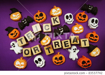 Halloween concept flat lay Trick or Treat alphabet letters on purple background 83537742