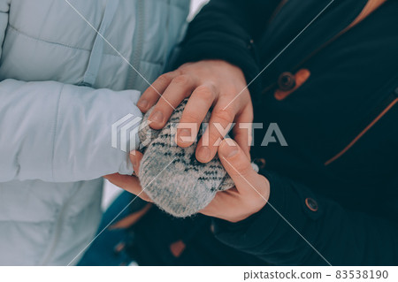 couple hold hands in warm clothes. winter theme. couple hold hands in warm clothes. winter theme. 83538190