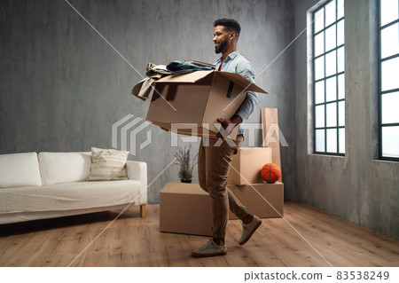 Happy young man holding packing boxes moving home, new living concept. Happy young man holding packing boxes moving home, new living concept. 83538249