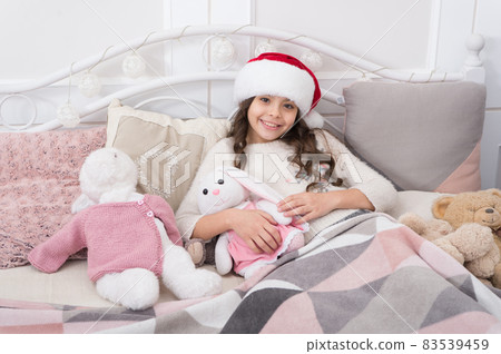 Cozy room. Child waiting christmas in bedroom. Kid lay Cozy room. Child waiting christmas in bedroom. Kid lay 83539459