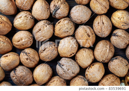 Walnuts on a brown wooden background. Walnuts on a brown wooden background. 83539691