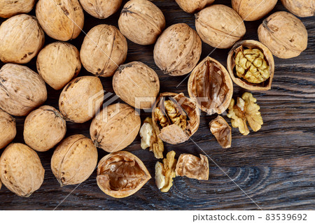 Walnuts on a brown wooden background. Walnuts on a brown wooden background. 83539692