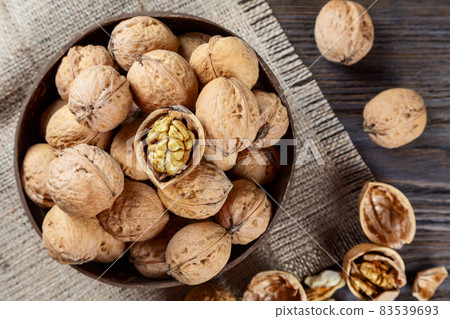 Walnuts on a brown wooden background. Walnuts on a brown wooden background. 83539693
