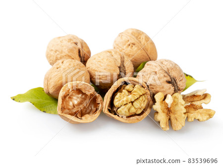 Walnuts and green leaves Walnuts and green leaves 83539696