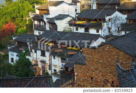 Gray roofs with white or brown walls. Ancient buildings in Huangling Village. 83539925