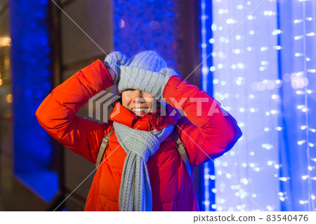 Girl in a night city snowflake Christmas city lights. Christmas and winter holidays concept. 83540476