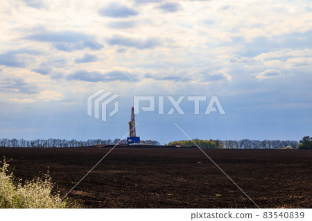 Land oil drilling rig on the field 83540839