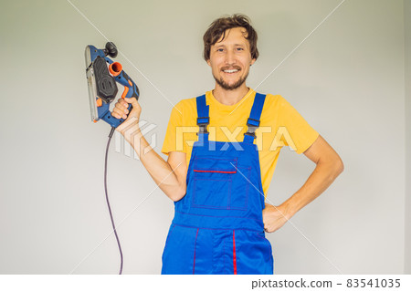 Carpenter with grinder and plane. Woodworking, professional 83541035