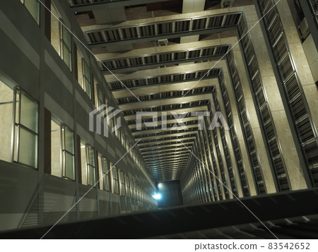 Overlooking the courtyard from the upper floors of a skyscraper Overlooking the courtyard from the upper floors of a skyscraper 83542652