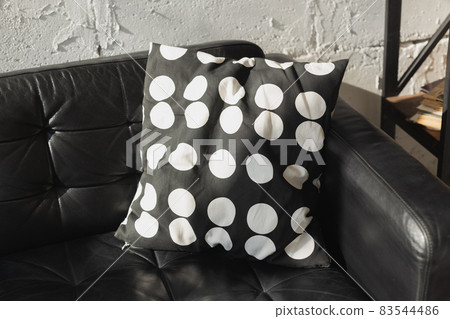 Black and white cushions on a sofa. Modern furniture. Loft interior Black and white cushions on a sofa. Modern furniture. Loft interior 83544486