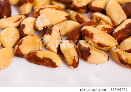 Roasted Brazil nuts on white surface Roasted Brazil nuts on white surface 83544751