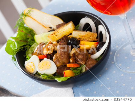 Salad with chicken hearts, fried cheese, quail eggs, pear, peach, wine 83544770